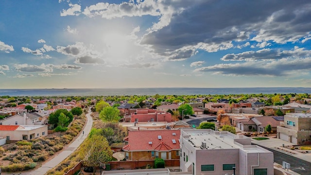 drone / aerial view with a water view and a residential view