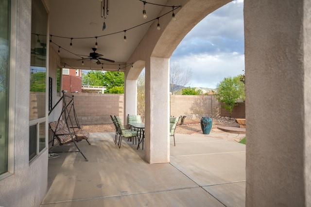 view of patio featuring a ceiling fan, a fenced backyard, and outdoor dining area