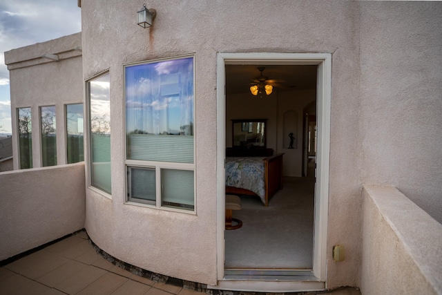 entrance to property featuring stucco siding