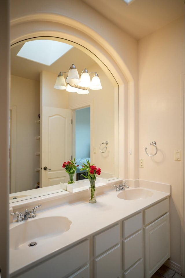 full bathroom with double vanity and a sink