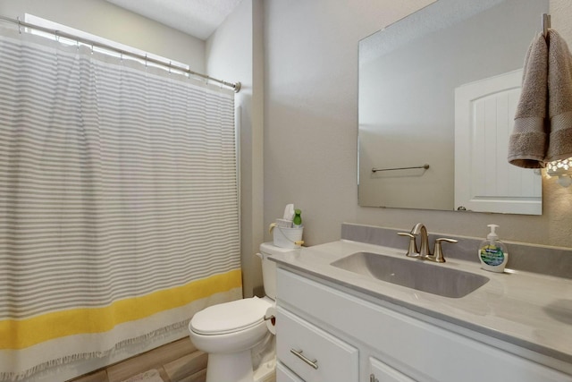 bathroom featuring toilet, a shower with curtain, and vanity