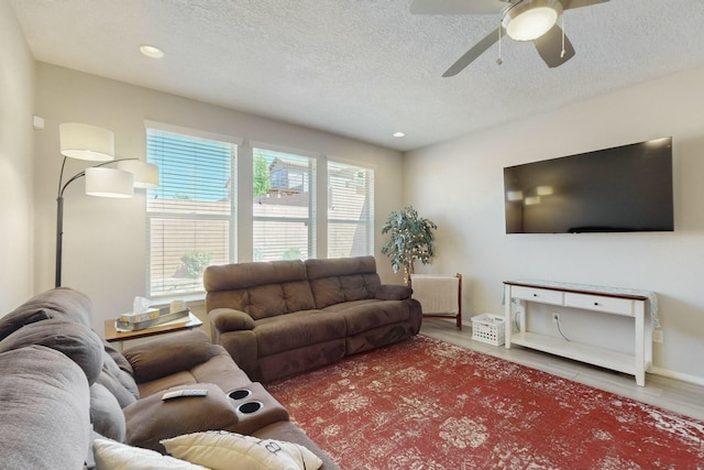 living room featuring recessed lighting, a ceiling fan, wood finished floors, and a textured ceiling