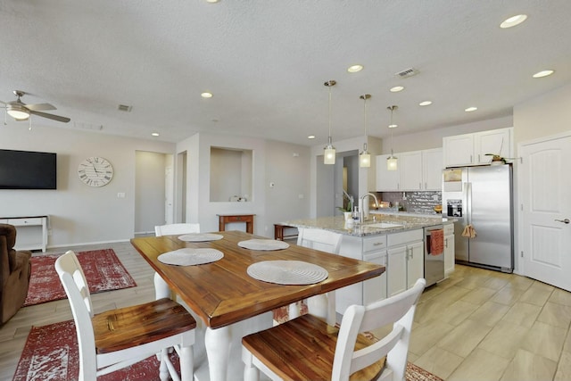 dining room with visible vents, recessed lighting, ceiling fan, and a textured ceiling