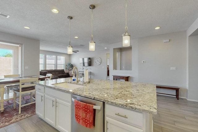 9112 Lansdowne Pl NE, Albuquerque, NM 87113 - kitchen with a sink, dishwasher, light wood-style floors, open floor plan, and recessed lighting