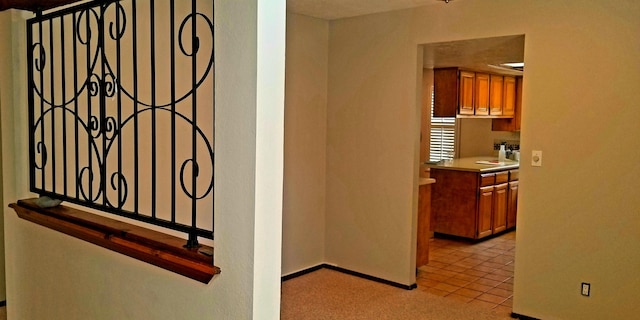 hall with light tile patterned floors and baseboards