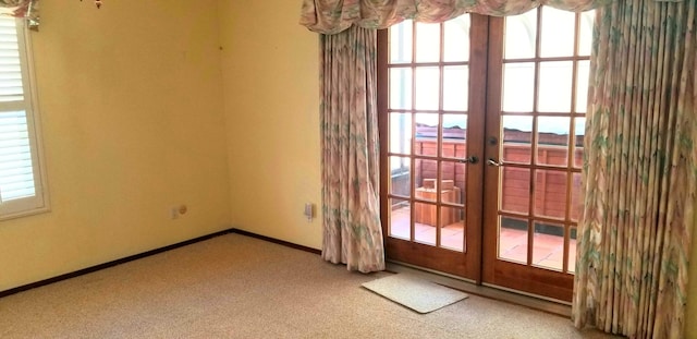 doorway to outside with carpet floors, french doors, and plenty of natural light