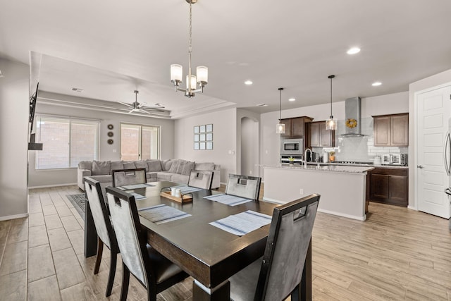 dining space with recessed lighting, light wood-style floors, visible vents, baseboards, and ceiling fan with notable chandelier