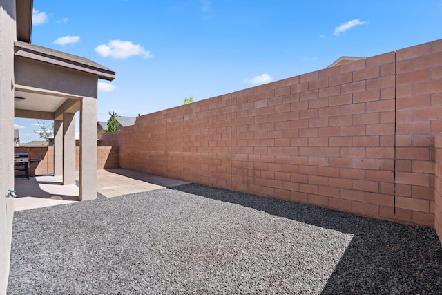view of yard with a patio area and a fenced backyard