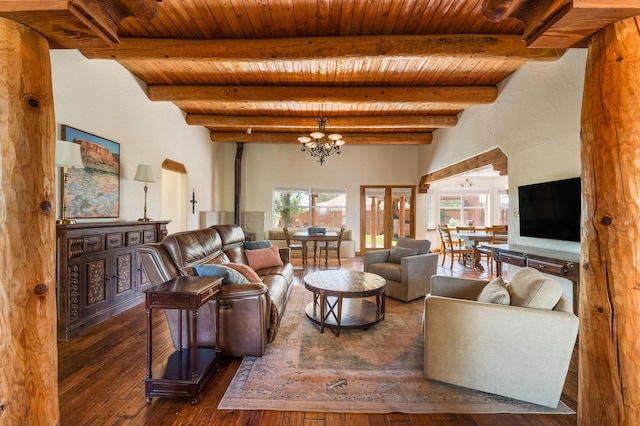 living area with an inviting chandelier, dark wood finished floors, beam ceiling, and wooden ceiling