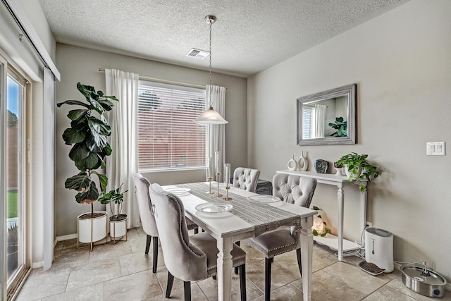 6952 Napoleon Rd NE, Rio Rancho, NM 87144 - dining room featuring visible vents, baseboards, and a wealth of natural light