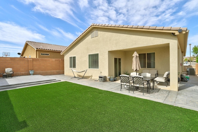6952 Napoleon Rd NE, Rio Rancho, NM 87144 - back of house with a fenced backyard, stucco siding, a yard, and central AC