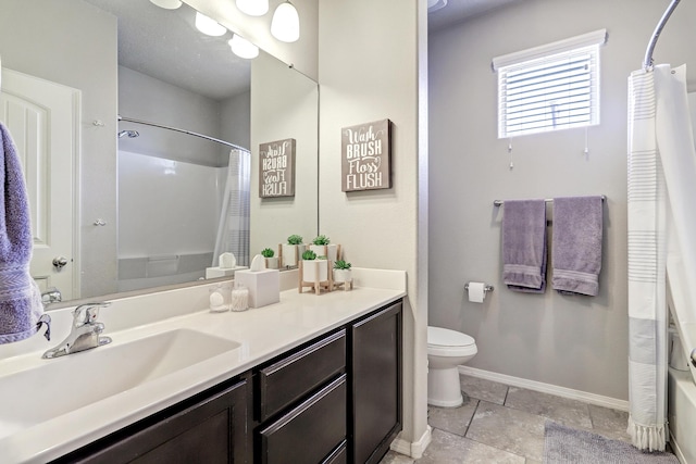6952 Napoleon Rd NE, Rio Rancho, NM 87144 - full bathroom featuring a shower with shower curtain, baseboards, vanity, toilet, and stone tile floors