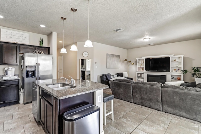 6952 Napoleon Rd NE, Rio Rancho, NM 87144 - kitchen with visible vents, dark brown cabinets, open floor plan, a sink, and stainless steel appliances