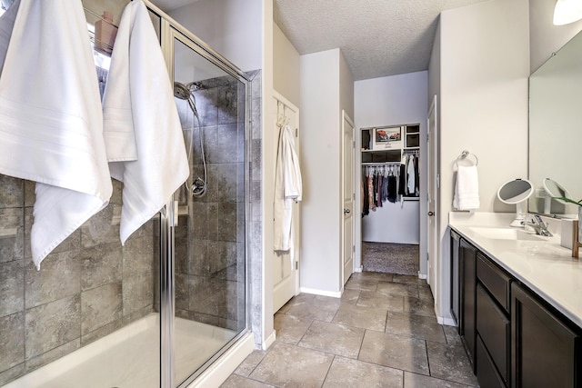 6952 Napoleon Rd NE, Rio Rancho, NM 87144 - full bathroom with vanity, baseboards, a stall shower, and a spacious closet