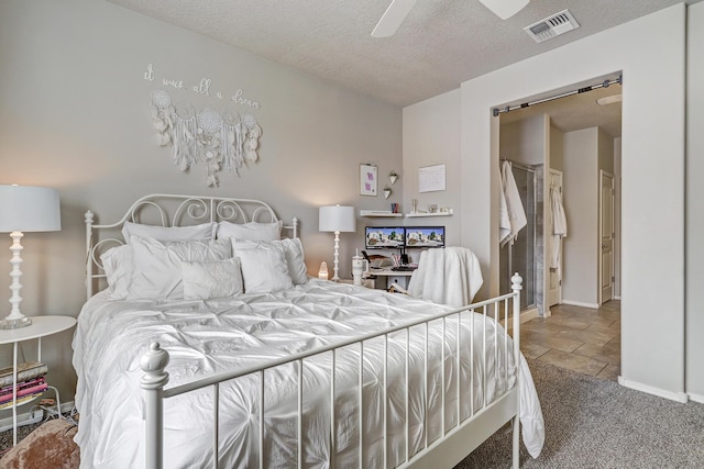 6952 Napoleon Rd NE, Rio Rancho, NM 87144 - bedroom featuring visible vents, stone tile floors, baseboards, ceiling fan, and a textured ceiling