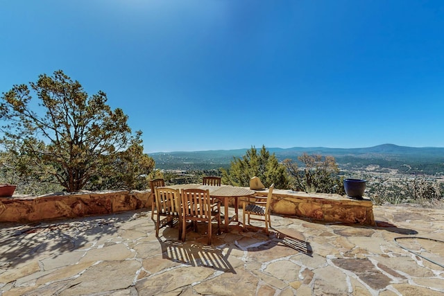 view of patio / terrace with a mountain view and outdoor dining space