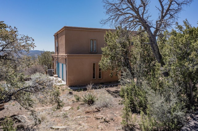 view of property exterior featuring stucco siding and central AC unit