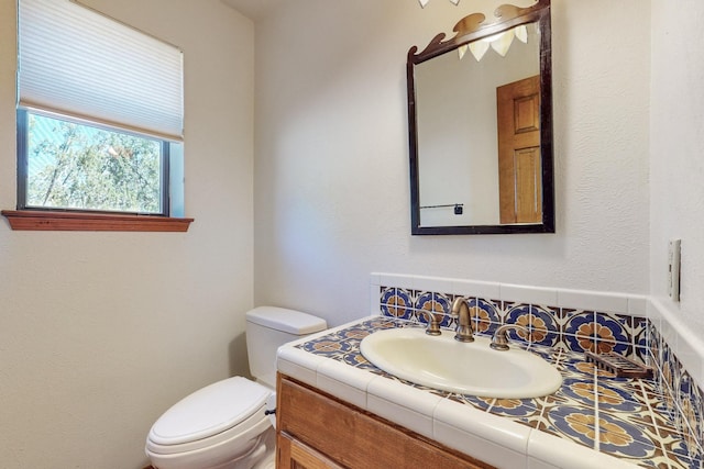 bathroom with toilet and vanity