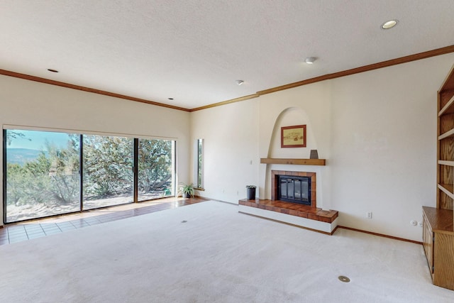 unfurnished living room featuring ornamental molding, recessed lighting, a tiled fireplace, and carpet