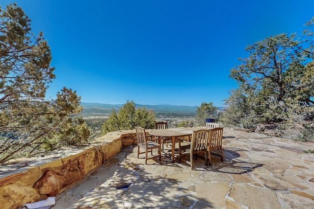 view of patio / terrace with a mountain view and outdoor dining area