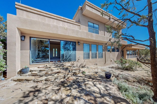 back of house featuring stucco siding