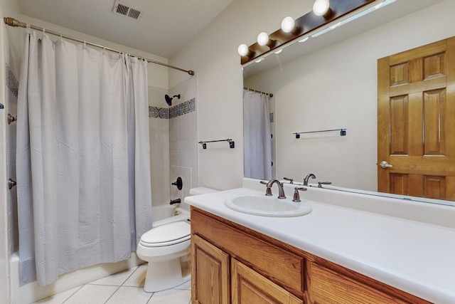 bathroom featuring tile patterned floors, toilet, vanity, visible vents, and shower / tub combo with curtain