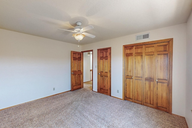 unfurnished bedroom with baseboards, visible vents, a closet, and carpet
