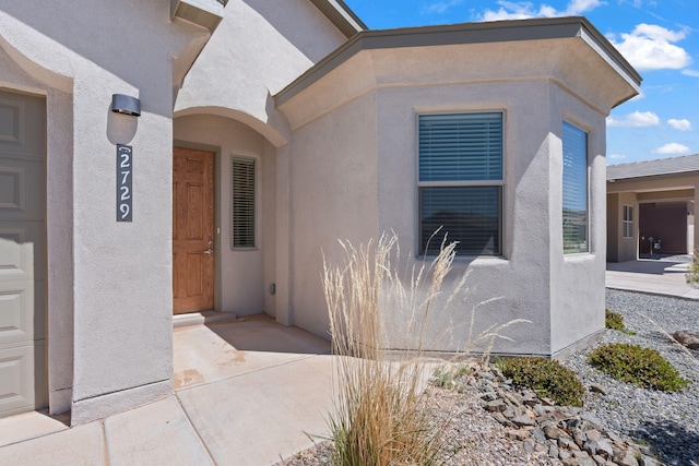 property entrance with stucco siding