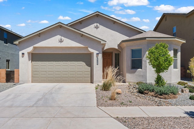 single story home featuring an attached garage, stucco siding, and concrete driveway