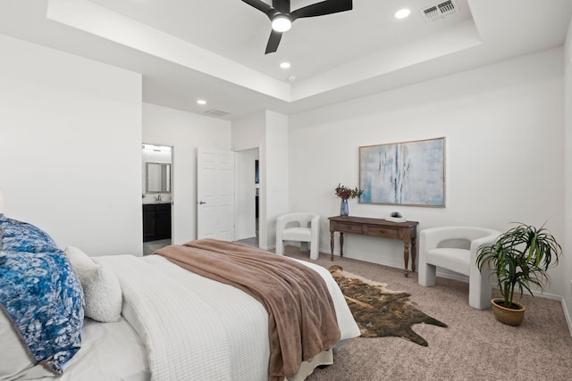 carpeted bedroom featuring connected bathroom, ceiling fan, recessed lighting, a tray ceiling, and visible vents