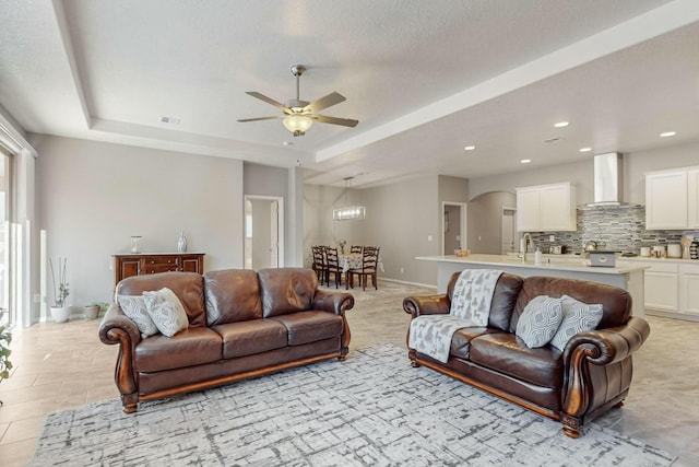 4017 Windy Rd NE, Rio Rancho, NM 87144 - living room featuring visible vents, recessed lighting, a raised ceiling, and a ceiling fan