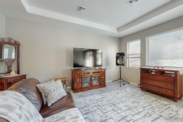 4017 Windy Rd NE, Rio Rancho, NM 87144 - living room with visible vents, a raised ceiling, and baseboards