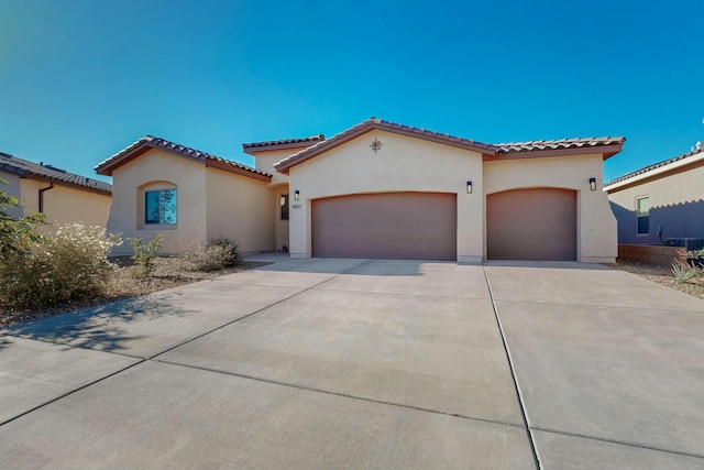 4017 Windy Rd NE, Rio Rancho, NM 87144 - mediterranean / spanish house with a tile roof, stucco siding, driveway, and an attached garage