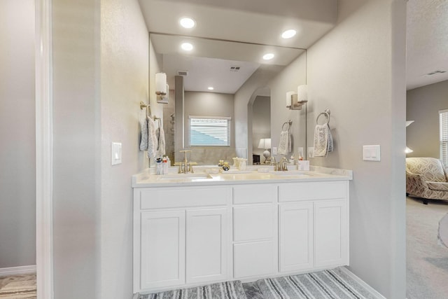 4017 Windy Rd NE, Rio Rancho, NM 87144 - bathroom with baseboards, connected bathroom, and a sink