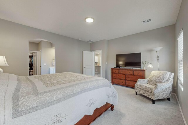 4017 Windy Rd NE, Rio Rancho, NM 87144 - bedroom featuring baseboards, visible vents, arched walkways, and light carpet