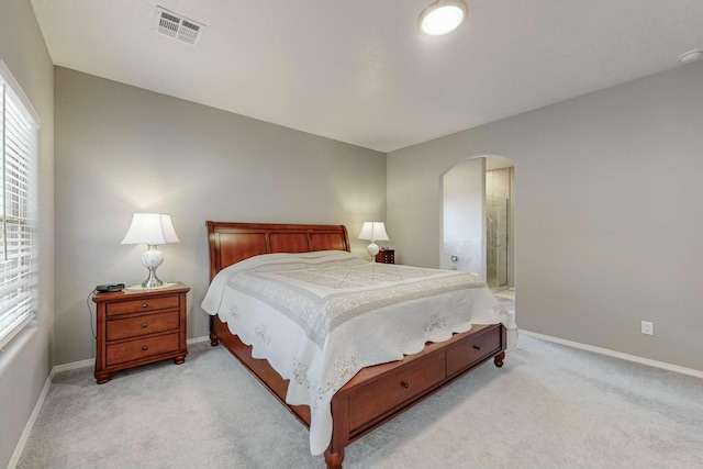 4017 Windy Rd NE, Rio Rancho, NM 87144 - bedroom with light colored carpet, visible vents, baseboards, and arched walkways