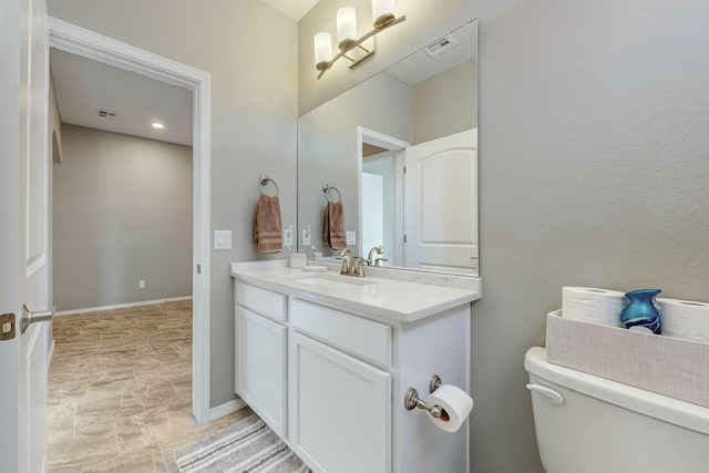 4017 Windy Rd NE, Rio Rancho, NM 87144 - bathroom with marble finish floor, visible vents, toilet, and vanity