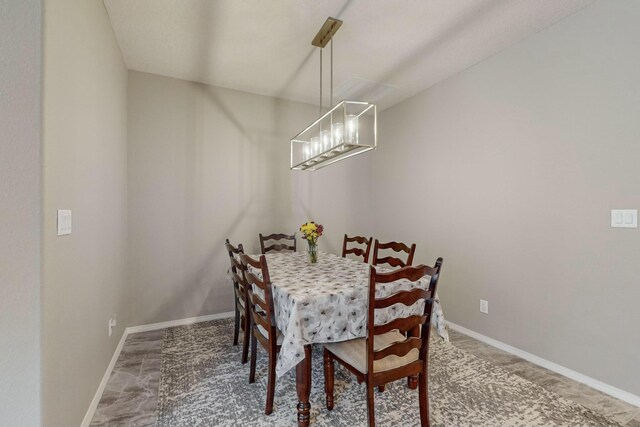 4017 Windy Rd NE, Rio Rancho, NM 87144 - dining area featuring a chandelier and baseboards