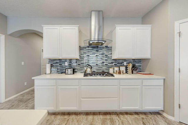 4017 Windy Rd NE, Rio Rancho, NM 87144 - kitchen with island range hood, white cabinetry, decorative backsplash, and light countertops