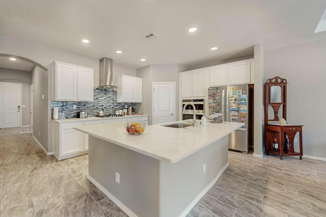 4017 Windy Rd NE, Rio Rancho, NM 87144 - kitchen featuring appliances with stainless steel finishes, wall chimney range hood, a large island, a sink, and visible vents