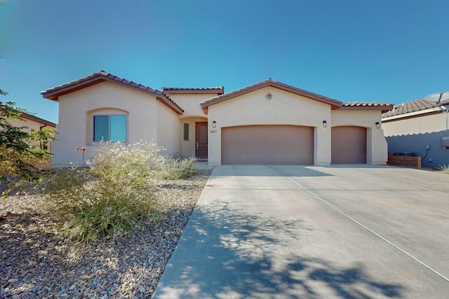 4017 Windy Rd NE, Rio Rancho, NM 87144 - mediterranean / spanish-style house with stucco siding, concrete driveway, an attached garage, and a tile roof