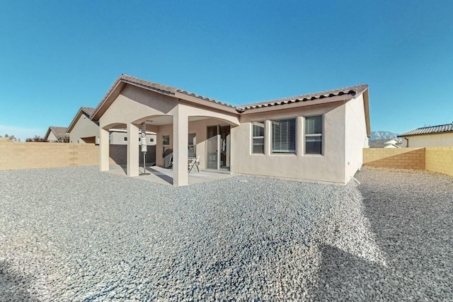 4017 Windy Rd NE, Rio Rancho, NM 87144 - back of house featuring stucco siding, a tiled roof, a patio area, and a fenced backyard