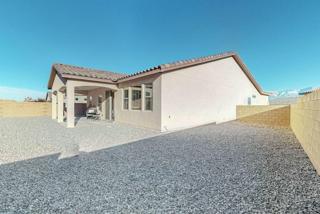 4017 Windy Rd NE, Rio Rancho, NM 87144 - back of house with stucco siding, a fenced backyard, and a patio area