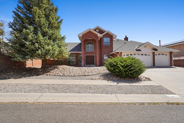 8200 Corona Ave NE, Albuquerque, NM 87122 - traditional-style house featuring a garage, brick siding, a chimney, driveway, and roof with shingles