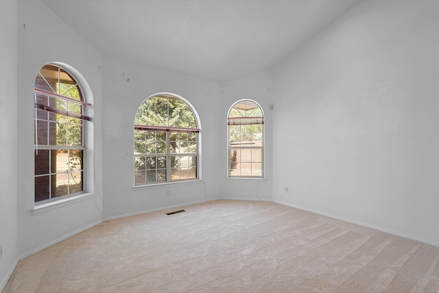 8200 Corona Ave NE, Albuquerque, NM 87122 - carpeted spare room with visible vents, vaulted ceiling, and baseboards