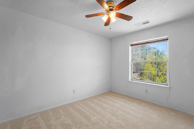 8200 Corona Ave NE, Albuquerque, NM 87122 - empty room with baseboards, visible vents, a textured ceiling, and light colored carpet