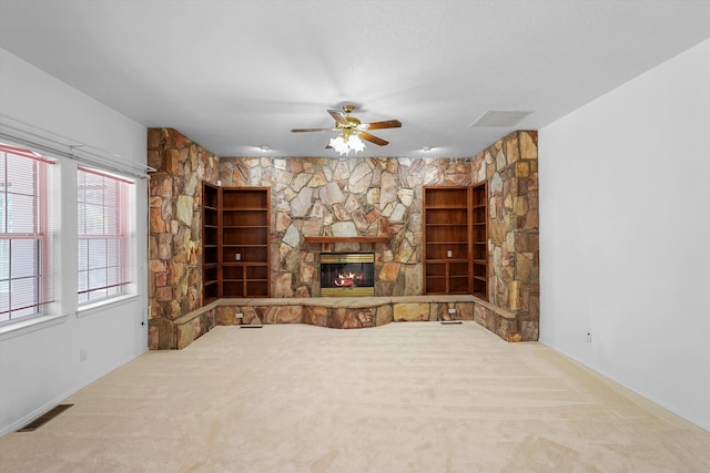 8200 Corona Ave NE, Albuquerque, NM 87122 - unfurnished living room with visible vents, a ceiling fan, carpet, and a fireplace