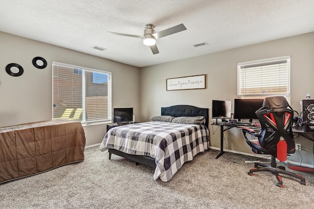 bedroom featuring baseboards, visible vents, ceiling fan, and carpet