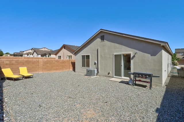 back of property featuring central air condition unit, stucco siding, and a fenced backyard