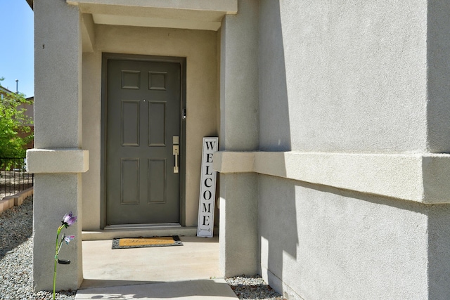view of exterior entry with stucco siding